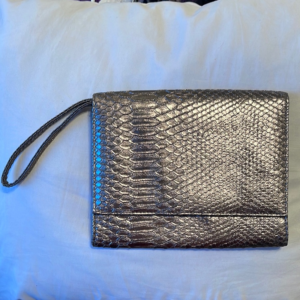 Neiman Marcus wristlet. Silver. Shine pulls bronze or gray depending. 9.5”x5.5”